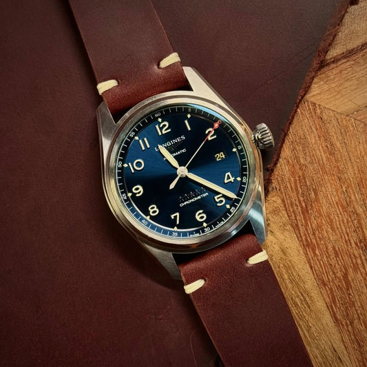 longings spirit on a Tempesti Baku brown leather strap on a wooden surface